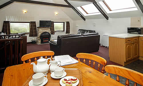 Open plan lounge with well equipped kitchen and dining area.